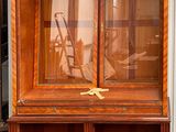 a large wooden cabinet with a glass door on it