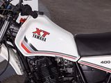 a white and black motorcycle parked in a parking lot