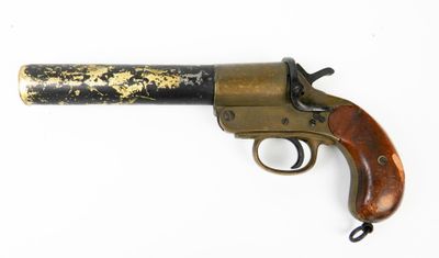gros plan d'un pistolet avec un manche en bois sur une surface blanche