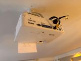 a video projector hanging from the ceiling in a room