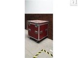 an image of a red case sitting on top of a cement floor