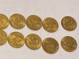 a bunch of gold coins sitting on top of a white surface