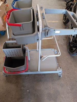a small cart with two buckets on it in a garage