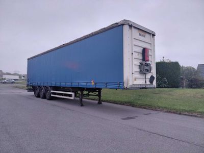 a large blue trailer parked on the side of the road