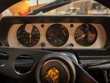 a steering wheel and dashboard of a car with gauges