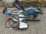 a blue and black circular saw sitting on the ground