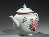 a white tea pot with a flower design on it