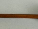 a pipe with a wooden handle on a white surface