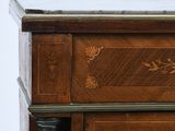 a close up of a wooden cabinet with a marble top