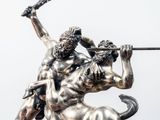 a statue of a man riding a bull with a sword