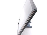 a tablet computer sitting on a stand on a white surface