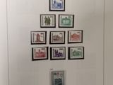 german postage stamps displayed on a white wall in a museum