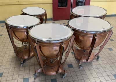 four different types of musical instruments sitting on the floor