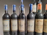 several bottles of wine are lined up in a row on a shelf