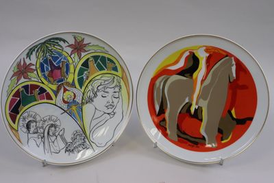 two plates with a painting of a man and a woman on them