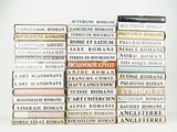 several books stacked on top of each other on a white surface