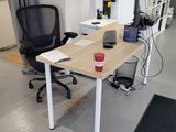 a desk with a chair and a computer on it