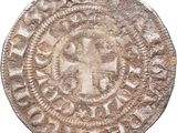 a close up of a coin with a cross on it
