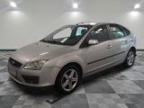 a picture of a silver ford focus parked in a garage