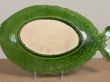 a green plate with a fish shaped design on it