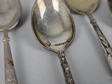 five spoons and two spoons on a table