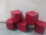 six red dice sitting on top of each other on a table