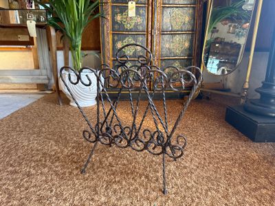 a wrought iron chair in the middle of a living room