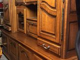 a large wooden cabinet in the middle of a room