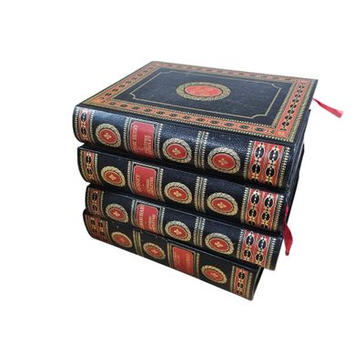 three books stacked on top of each other on a white surface