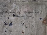 a graffiti on the wall of a building with writing on it