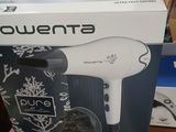 packaging of a hair dryer sitting on top of a table next to a blender