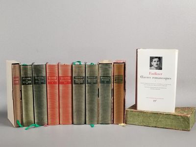 several books are stacked on top of each other on a table