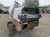 a truck that is sitting in the dirt near other vehicles