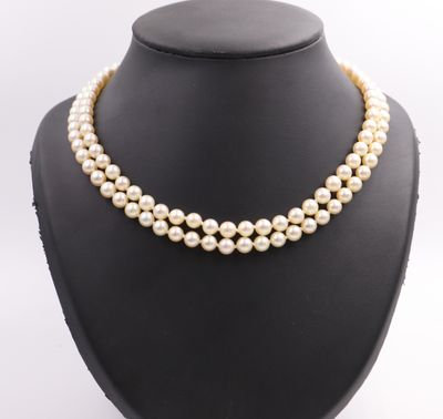 a three strand pearl necklace on a mannequin display