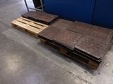two pallets of wood sit on top of a pallet in front of a blue wall