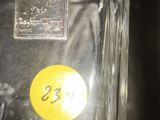 a glass vase with a yellow sticker on it