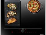 a black stove top with a pan of food on it