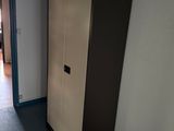 a tall cabinet in the corner of a room
