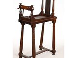 an old wooden chair with a wooden seat and wooden legs