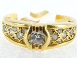 a close up of a gold ring with diamonds on it