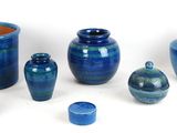 many blue vases that are sitting on a white surface