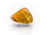 a close up of a yellow tiger eye stone on a white surface