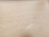 a wooden cutting board with a knife on top of it