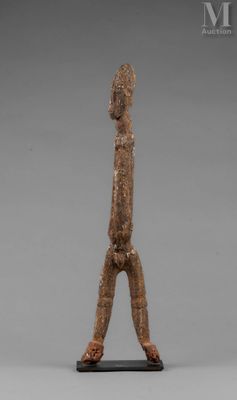a statue of a man standing on one leg with his hands in the air