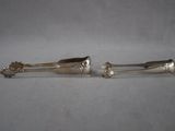 pair of silver plated spoons on a white surface
