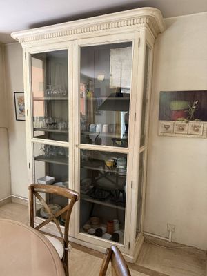 a table and chairs in a room with a cabinet