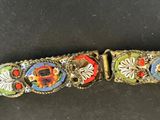 a close up of a metal belt with colorful buttons on it