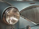 a close up of a car ' s front grill and headlight