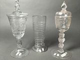three glass goblets sitting next to each other on a table