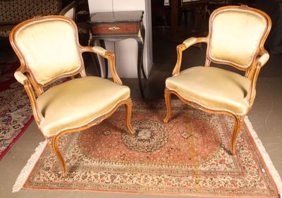 two chairs that are sitting on a rug on the floor